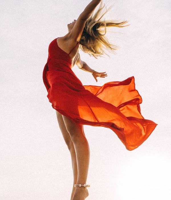 Woman feeling energetic and vibrant in a bright, open space.